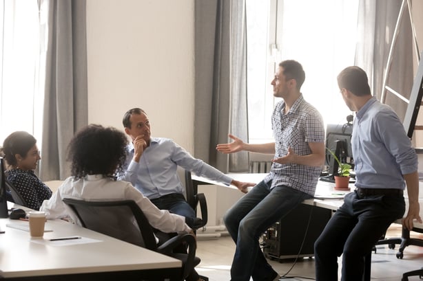 People seated in a group, talking.