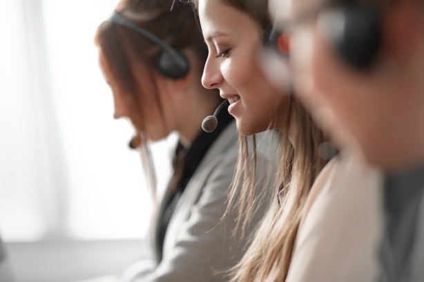 A photo of three people wearing headsets.